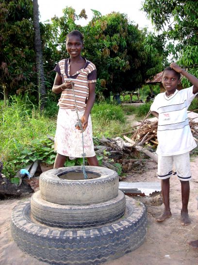 young-boy-and-girl-in-africa-collecting-water-from-an-uncovered-well-408x544.jpg